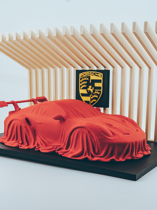 Porsche 911 GT3 RS covered on a diplay stand.