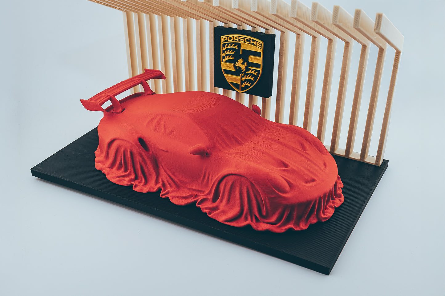 Porsche 911 GT3 RS covered on a diplay stand.
